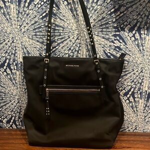 Nylon tote with leather straps, gold accents and laptop divider.